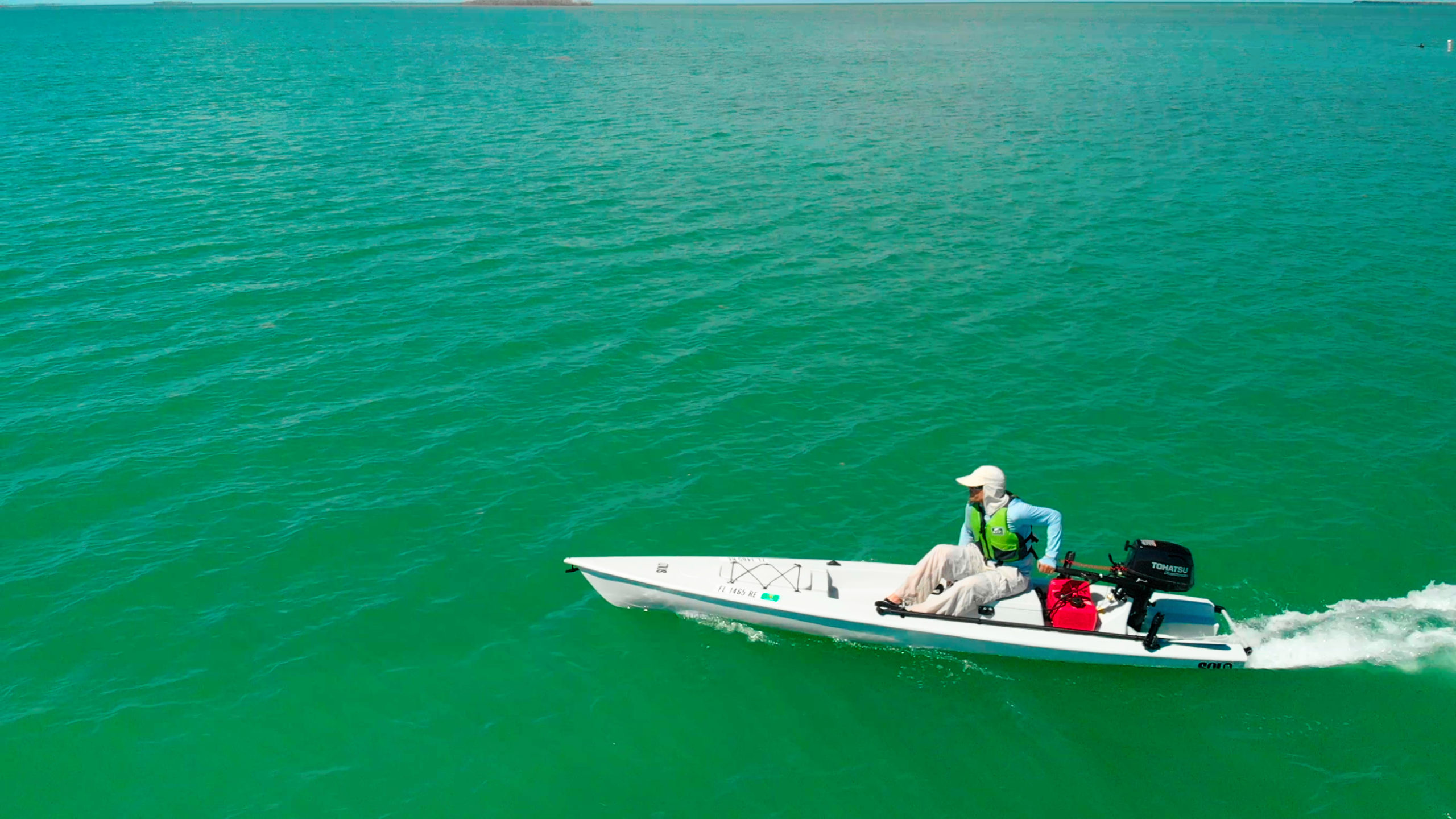 Motorized kayak motors across the bay