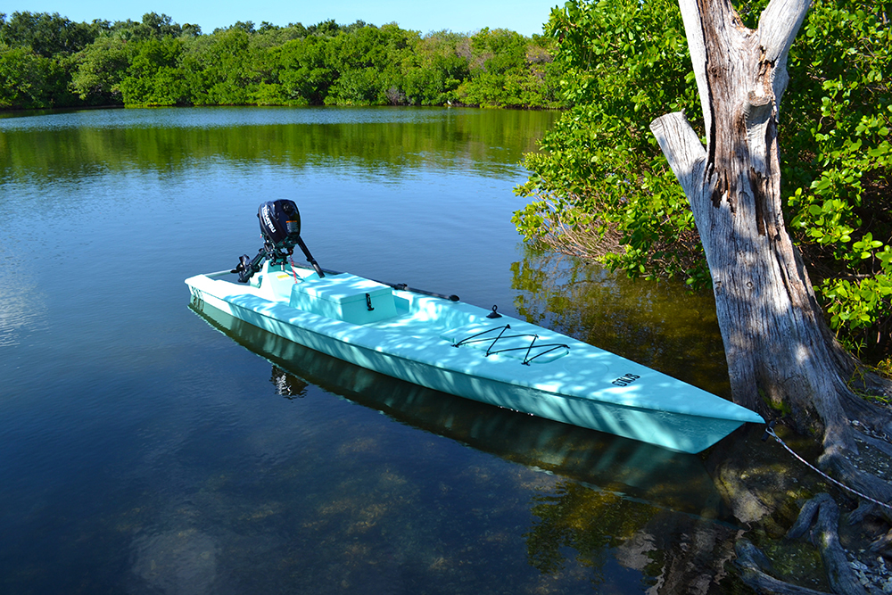 grey solo skiff in water tied to tree