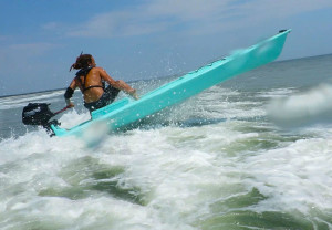 jumping a wave in a kayak