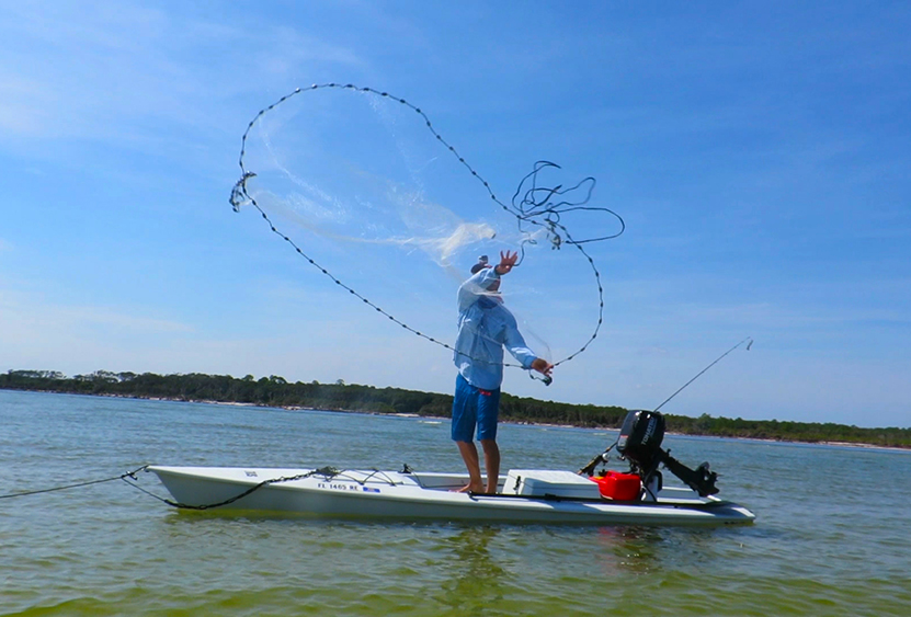 Cast net throwing from a fishing kayak