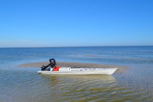 fishing kayak sitting on sand