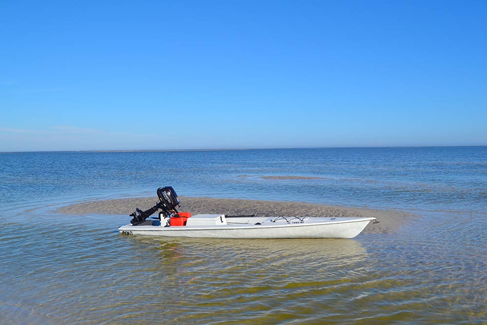 fishing kayak sitting on sand