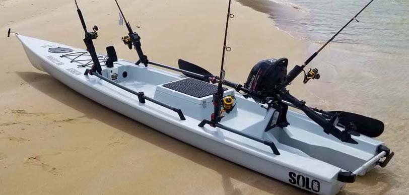 A Solo Skiff with custom rigging on the beach.